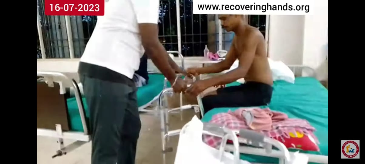 Volunteer assisting a patient at the hospital ward