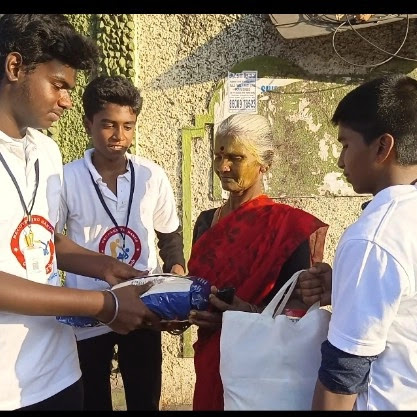 Volunteers handing groceries to an elderly woman